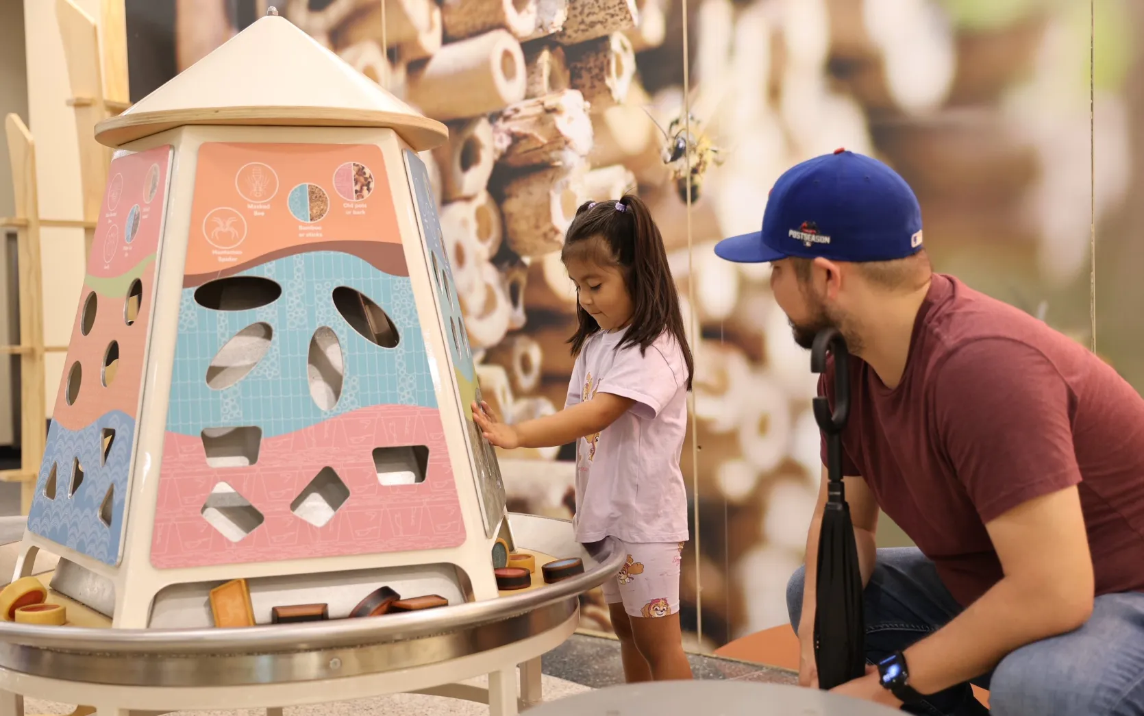 Picture of father and daughter interacting with the exhibit